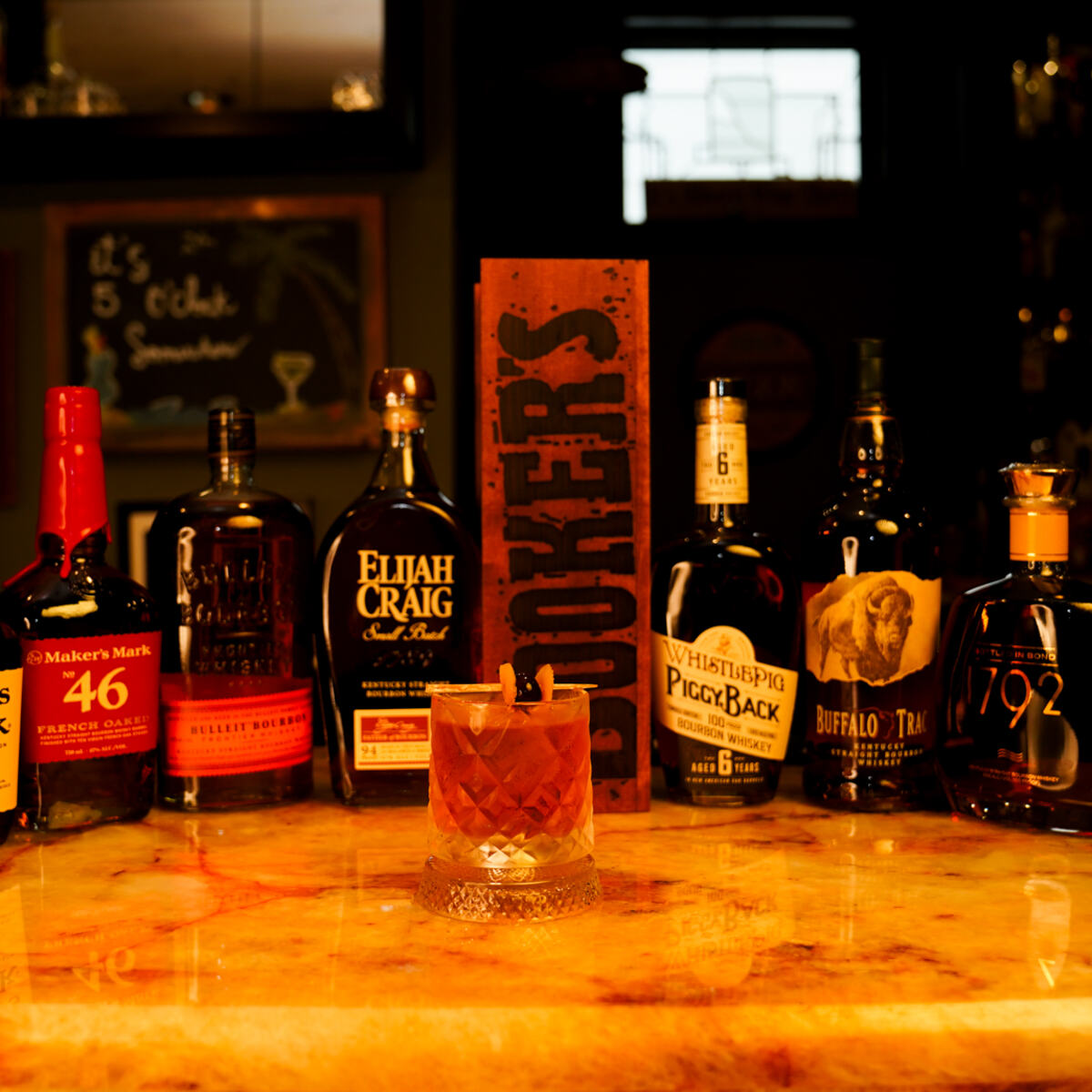 Bourbon bottles lined up on the bar