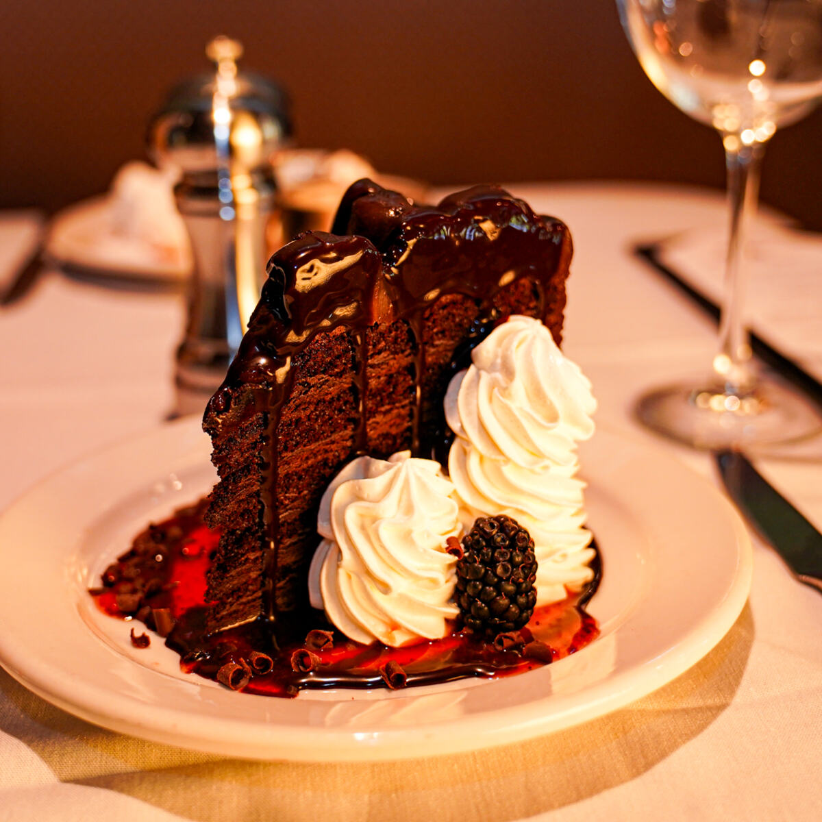 A tall slice of layered chocolate cake