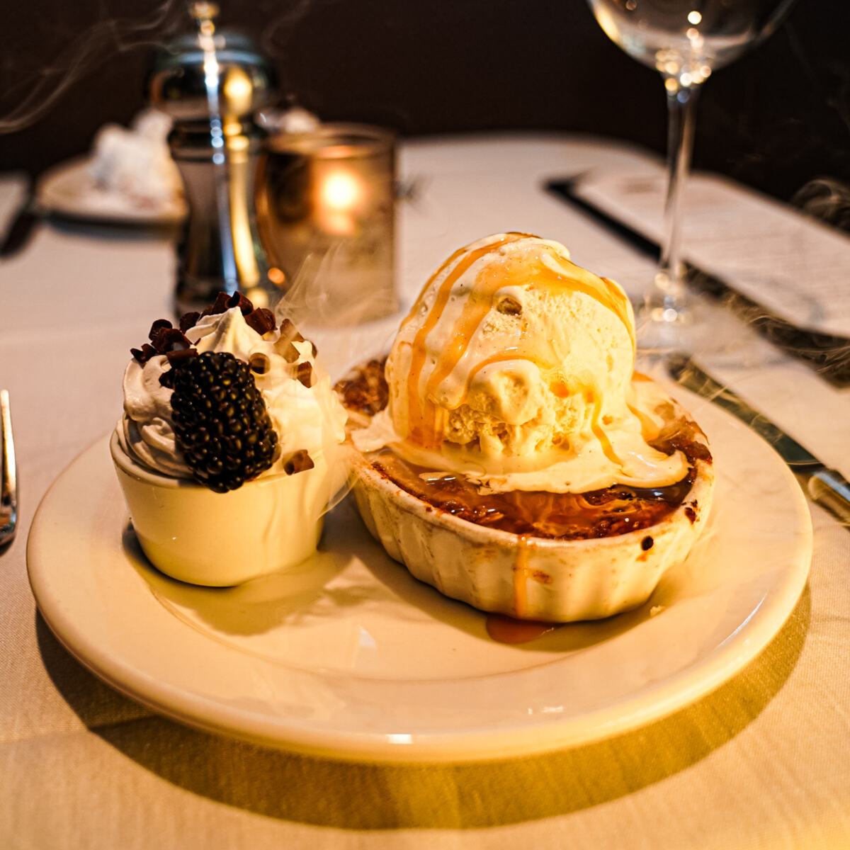 Two desserts with whipped cream and ice cream