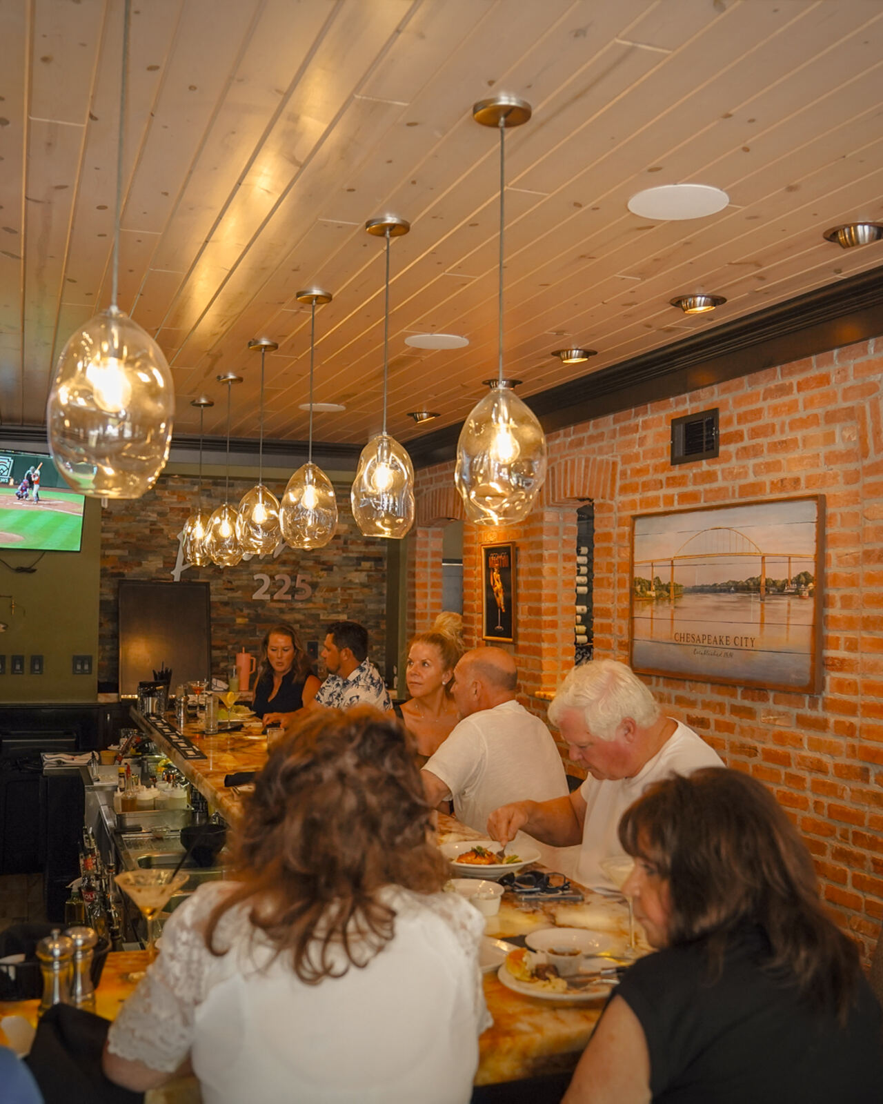 Guests at the bar at Prime 225 in warm evening light